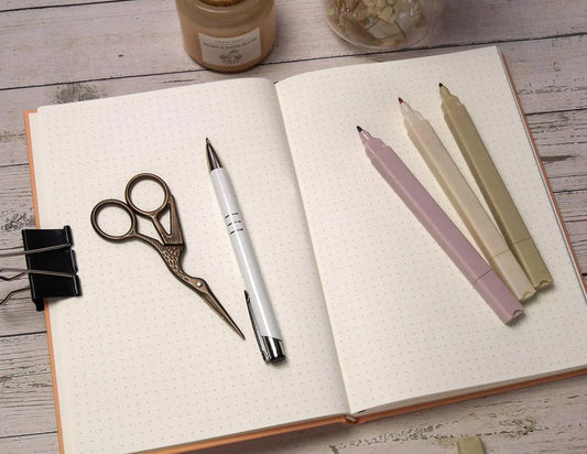 inside pages of A5 journal with dotted grid or lined layout, cream Munken paper 100gsm, perfect for bullet journaling and writing