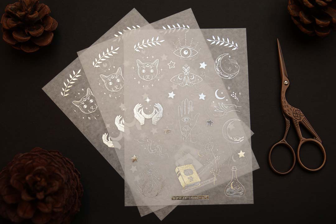 Washi sticker with silver foil print, magical symbols, cats, moths, moon symbols and witchy things