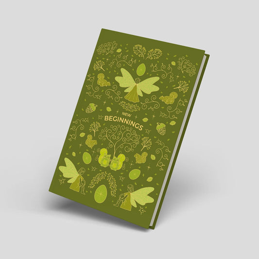 Green DIN A5 dot grid journal with fairy illustrations, ornamental trees, cats and decorative woodland-inspired details on the cover against a neutral background.