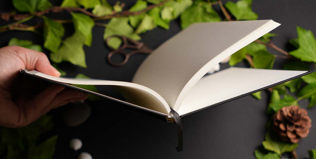 Flexible A5 hardcover journal with ribbon bookmark and premium Munken Pure paper, available in dot grid, lined, or blank.