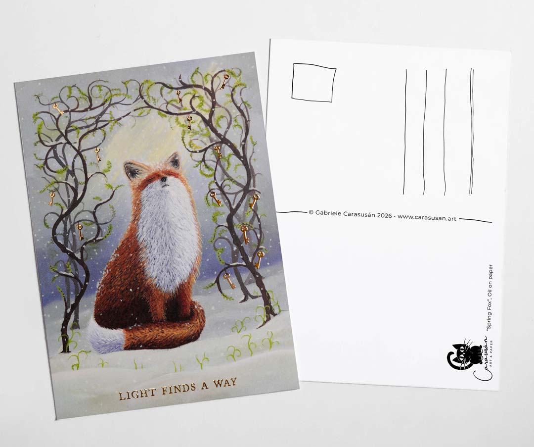 Front and back view of an A6 fox postcard featuring an original oil painting of a red fox in the snow beneath intertwined branches with gold foil keys and fresh green leaves. Gold foil text reads “Light Finds A Way”. The reverse side includes postcard address lines and space for a personal message.