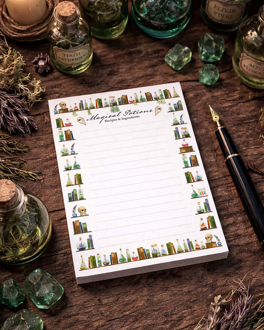 Witchy A6 notepad on a rustic wooden table surrounded by apothecary bottles and green crystals, moody atmosphere, magical stationery setup