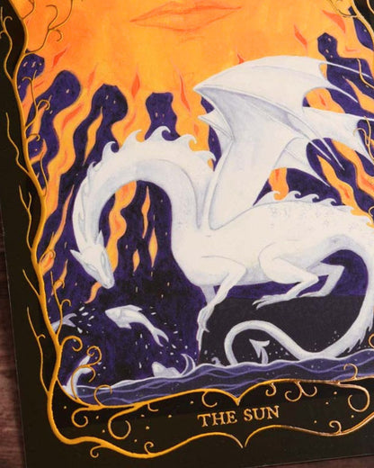 Detail of the white dragon and playful fish on The Sun Tarot postcard with shimmering gold foil accents.