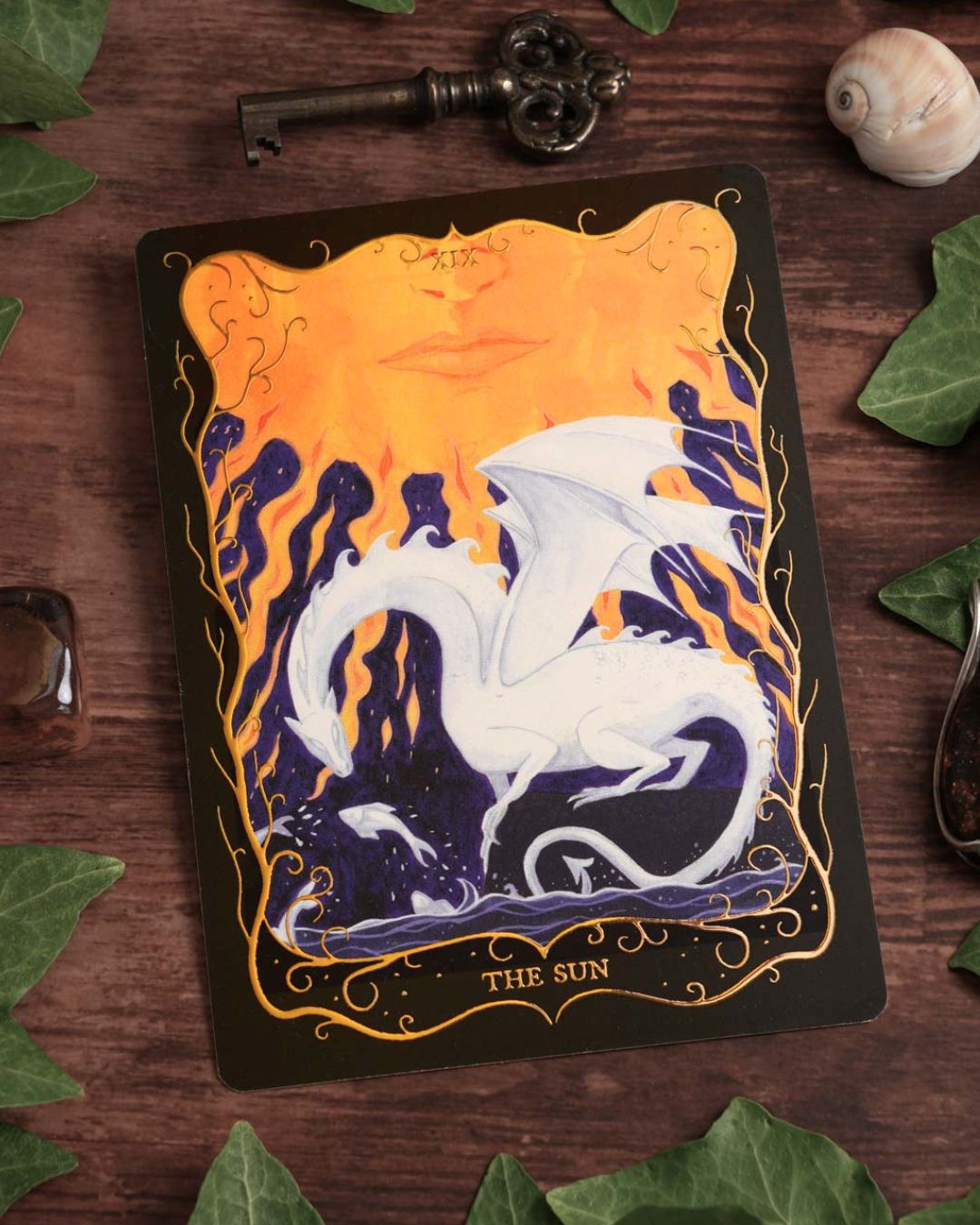 The Sun Tarot postcard featuring a hand-painted white dragon beneath a glowing sun with elegant gold foil details.