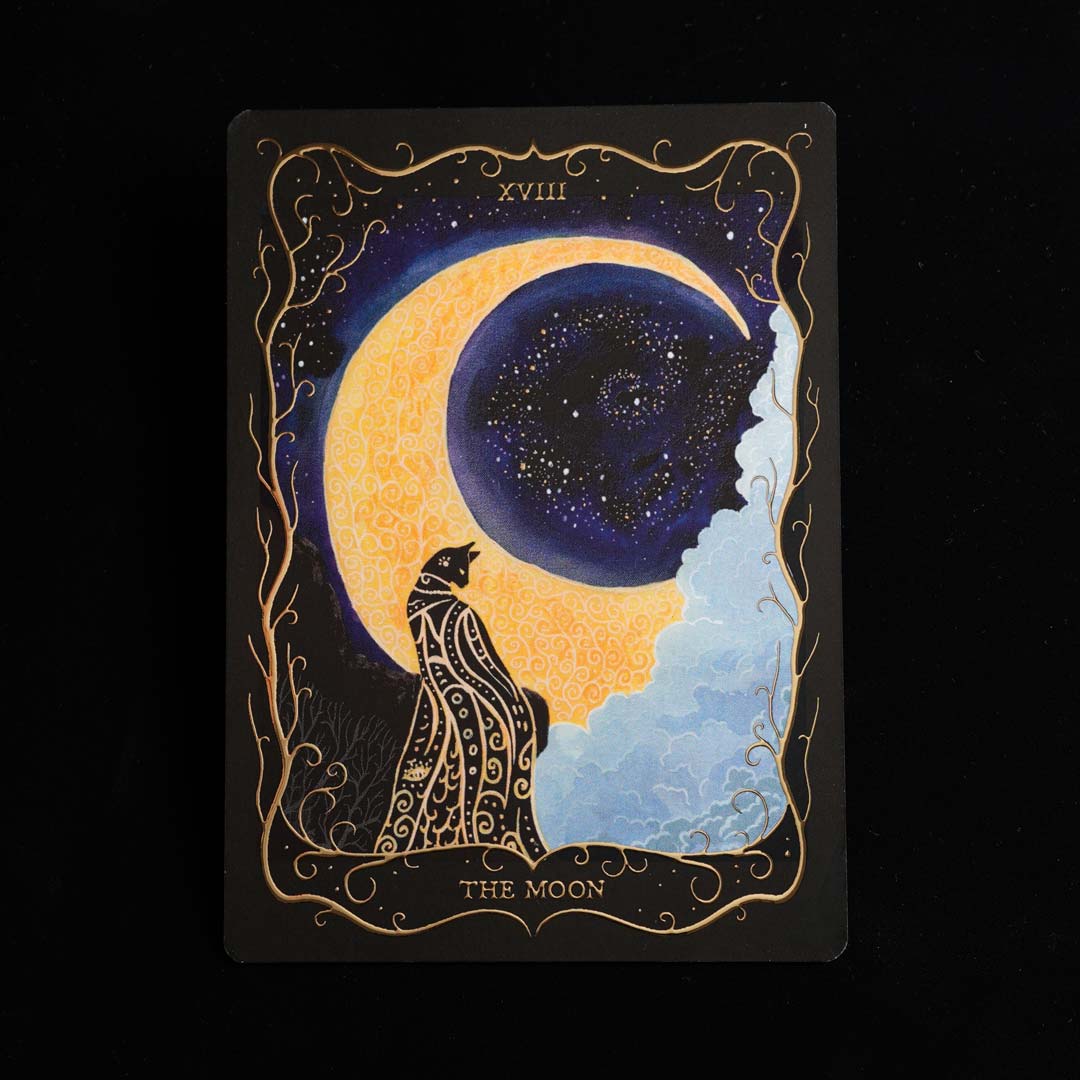 Hand-painted "The Moon" Tarot postcard with gold foil details, featuring a black cat beneath a glowing crescent moon against a black background.