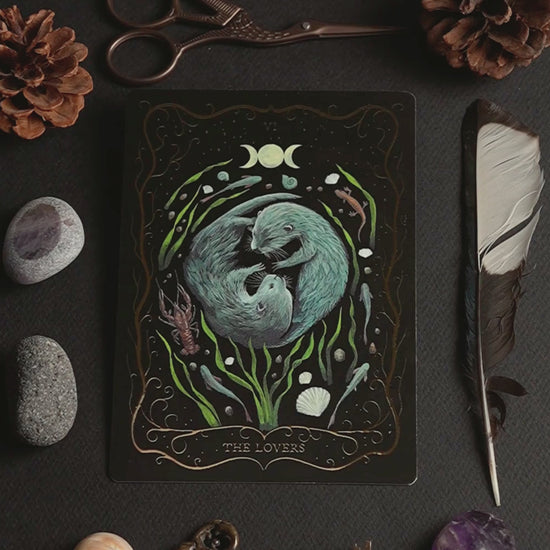 Product video of the hand-painted A6 Tarot postcard "The Lovers", showing the front, back, and shimmering gold foil details as the card is turned in the light.