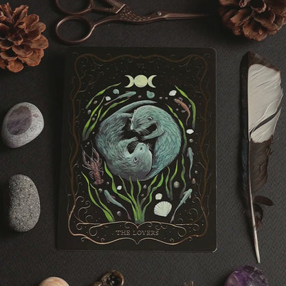 Product video of the hand-painted A6 Tarot postcard "The Lovers", showing the front, back, and shimmering gold foil details as the card is turned in the light.