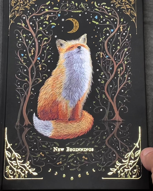 Witchy notebook "New Beginnings" with hand-painted fox illustration, gold foil moon phases and stars on black hardcover, A5 journal with Munken Pure paper.