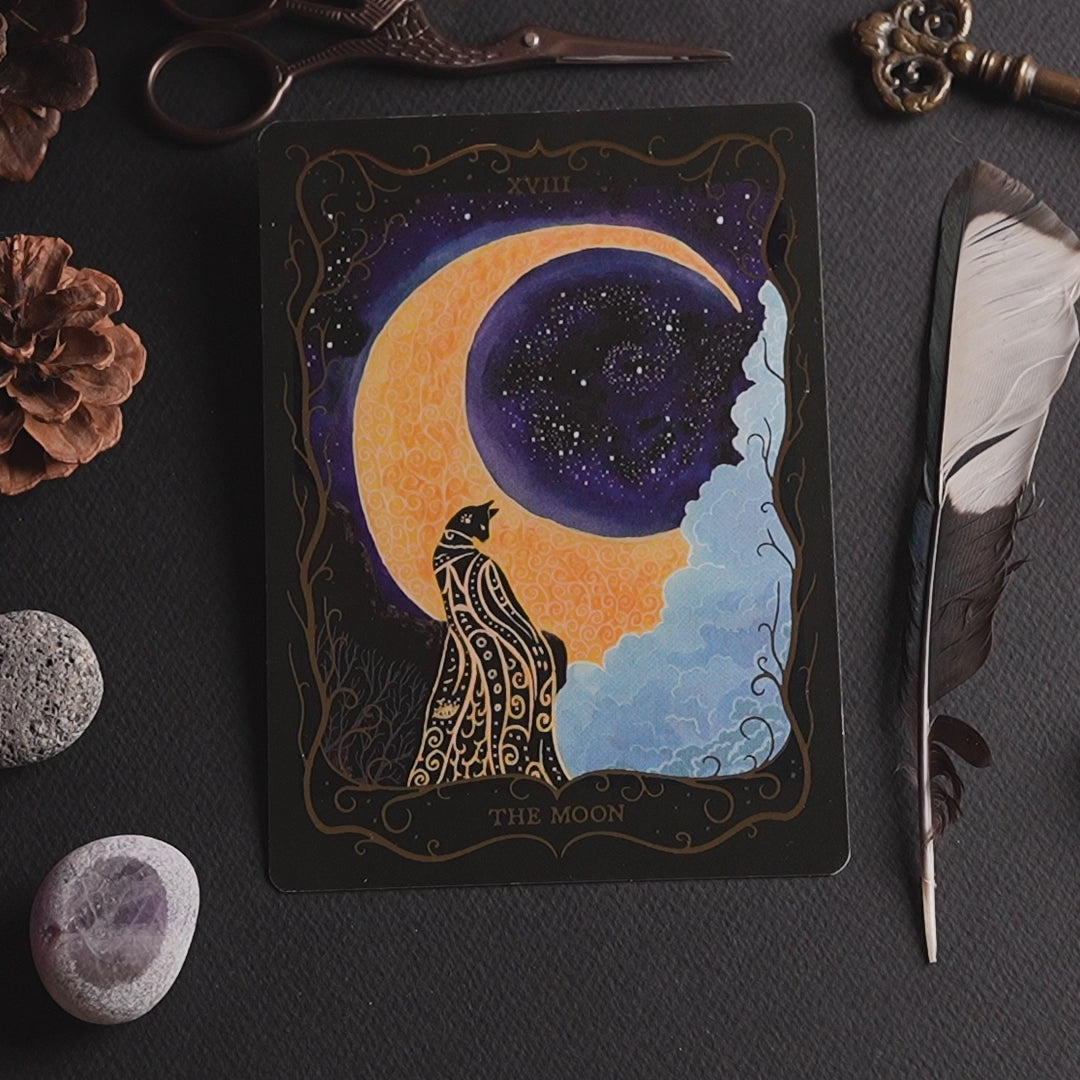 Close-up video of the "The Moon" Tarot postcard featuring hand-painted artwork, gold foil details, premium print quality and the postcard back.