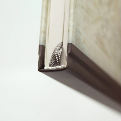 Close-up of the journal spine showing the grey ribbon bookmark, headband detail and durable hardcover binding.